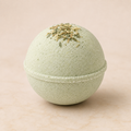 Cucumber Melon luxury bath bomb with dried herbs on ivory background