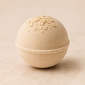 Honey Oat Crème' luxury bath bomb with oats on ivory background
