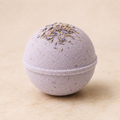 Lavender Lux luxury bath bomb with dried lavender on ivory background