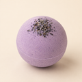 Lavender Recovery CBD bath bomb with dried lavender on ivory background