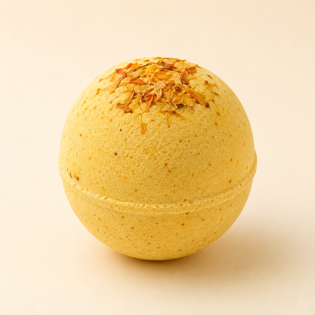 Mango Butter Recovery CBD bath bomb with dried flowers on ivory background